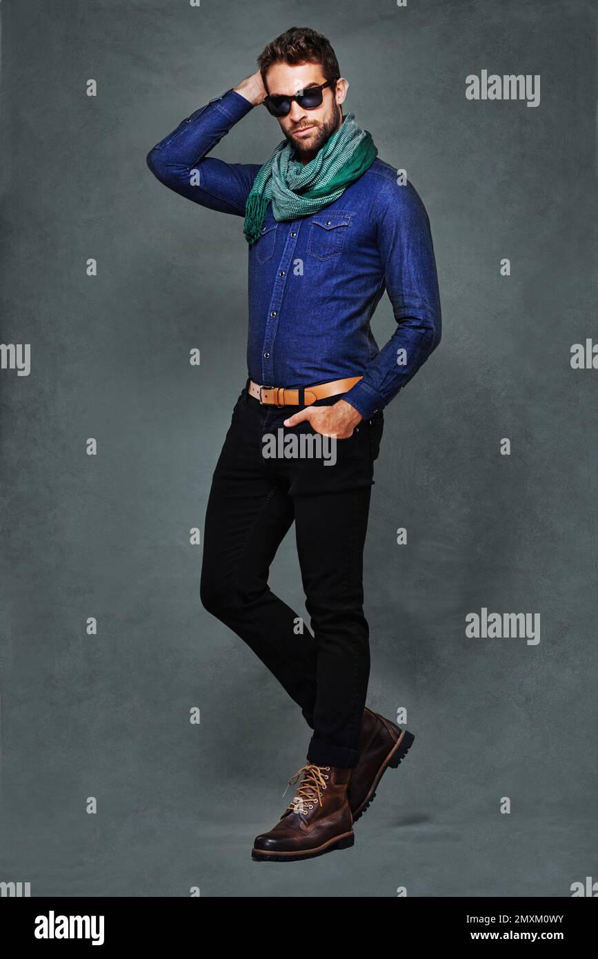 His style is eclectic and extremely creative. a fashionable young man dressed in denim. Stock Photo