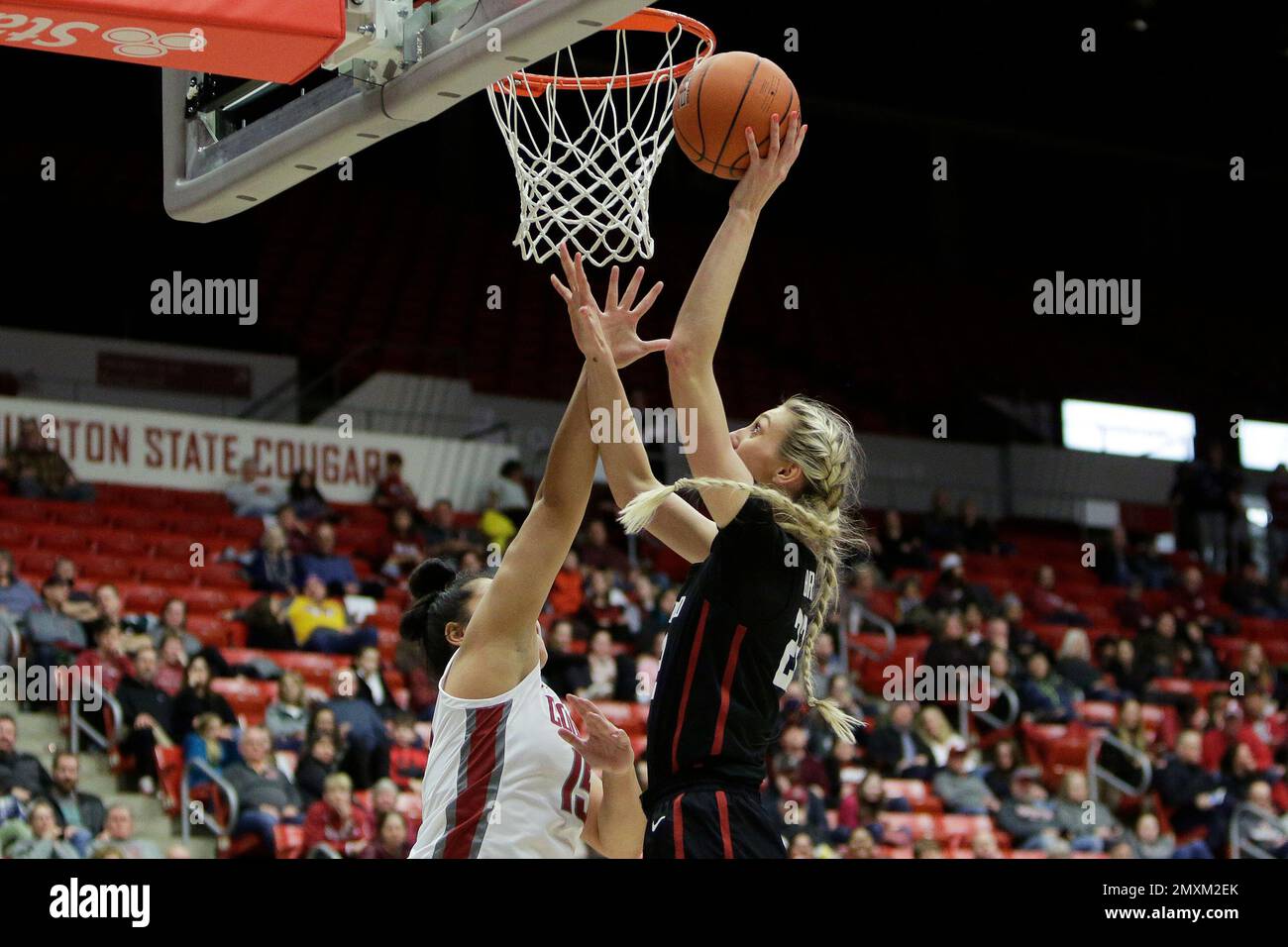 Stanford forward Cameron Brink, right, shoots while defended by
