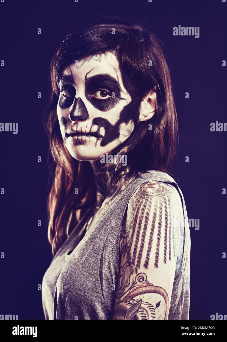 Remembering the dead. A woman with a traditional calaveras death mask painted on her face. Stock Photo