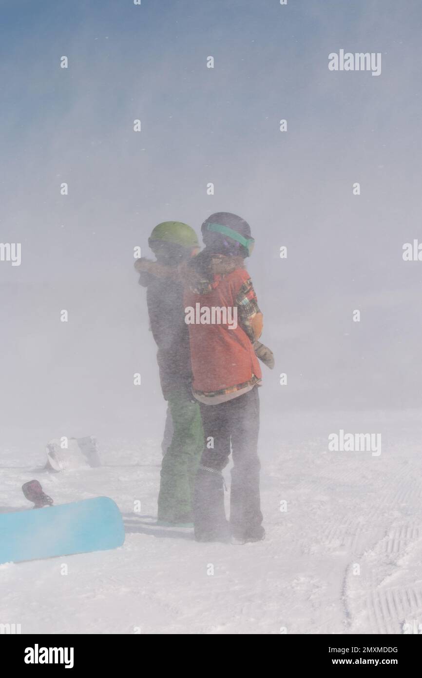 Two snowboarders standing in a blizzard Stock Photo