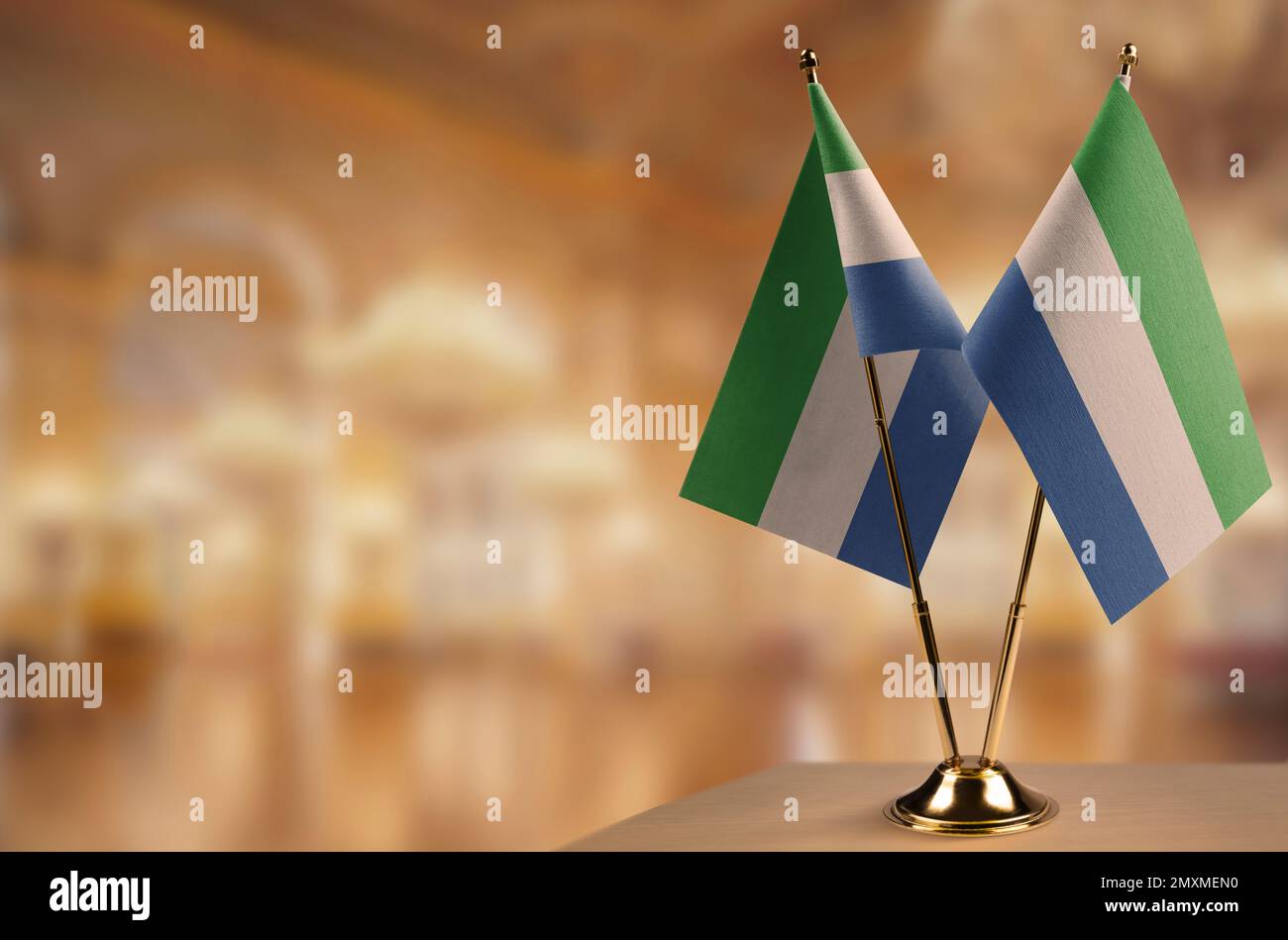 Small flags of the Sierra Leone on an abstract blurry background Stock ...