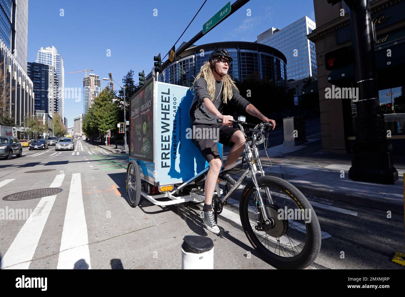 Cargo bike delivery driver Jesse Erickson wheels through a bicycle-only lane on a downtown street Wednesday, Oct
