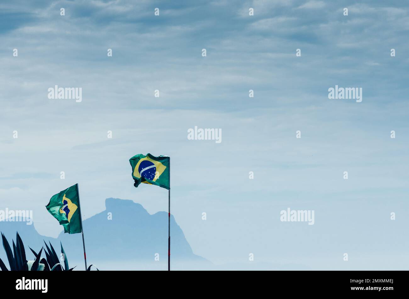 Brazilian flag with Pedra da Gavea at background in Rio de Janeiro, Brazil with lots of negative space Stock Photo