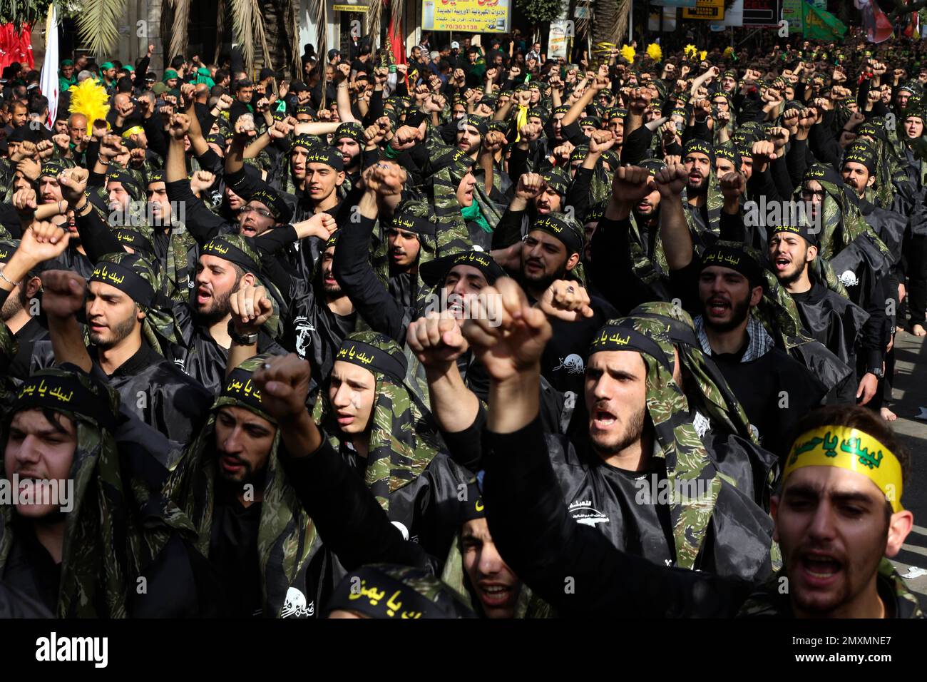 Shiite Lebanese members of Iranian-backed Hezbollah group, shout slogans as they march during the holy day of Ashoura, in a southern suburb of Beirut, Lebanon, Wednesday, Oct. 12, 2016. Lebanese Shiites mark Ashoura, the tenth day of the Islamic month of Muharram, to commemorate the Battle of Karbala in the 7th century when Imam Hussein, a grandson of Prophet Muhammad, was killed in present-day Iraq. (AP Photo/Hussein Malla) Stock Photo