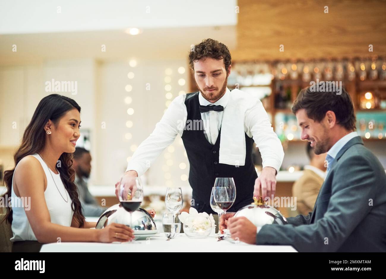 Couple, restaurant server and fine dining at table for valentines day