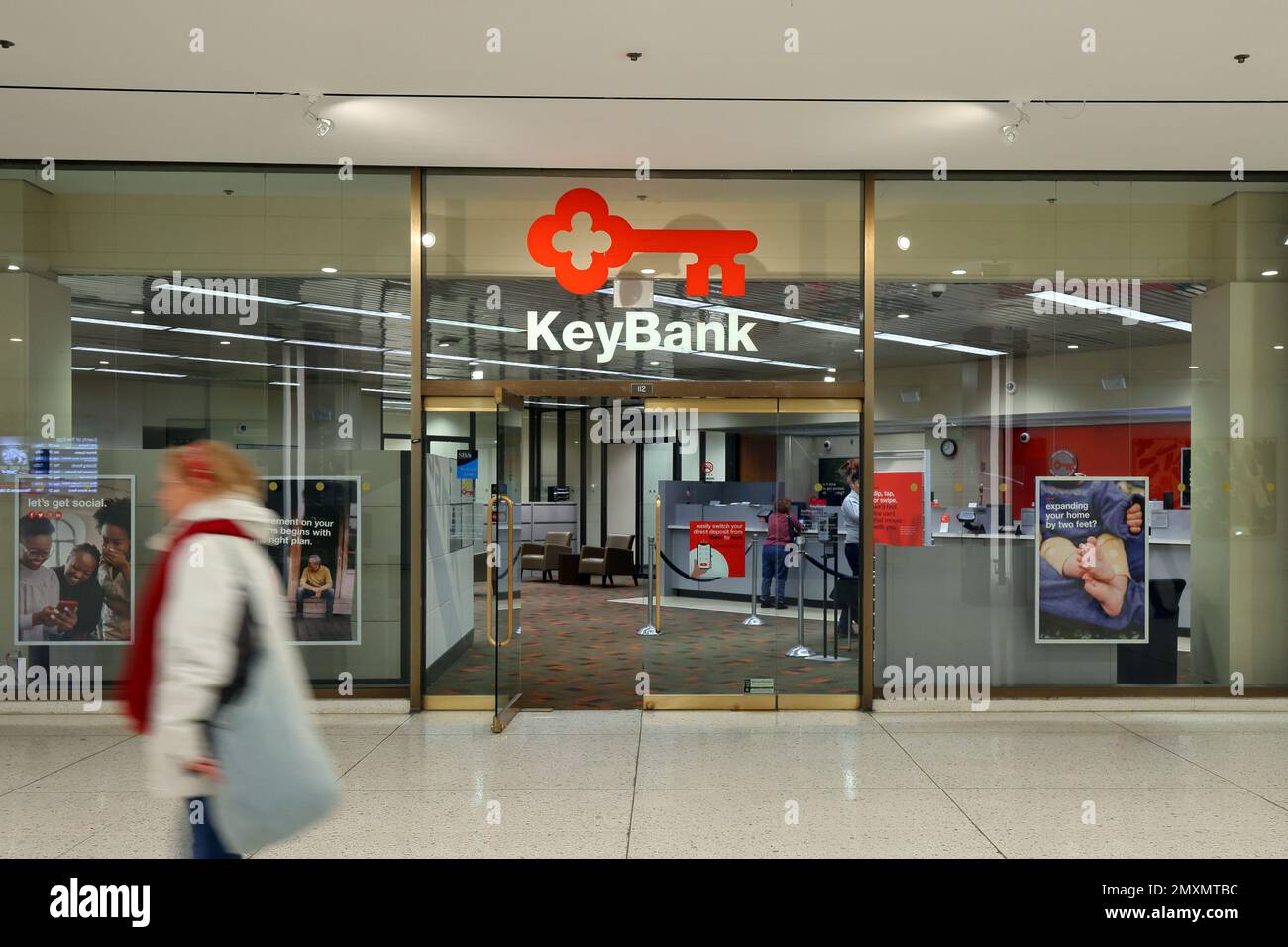 A person walks past a KeyBank bank branch in Albany, New York. Stock Photo