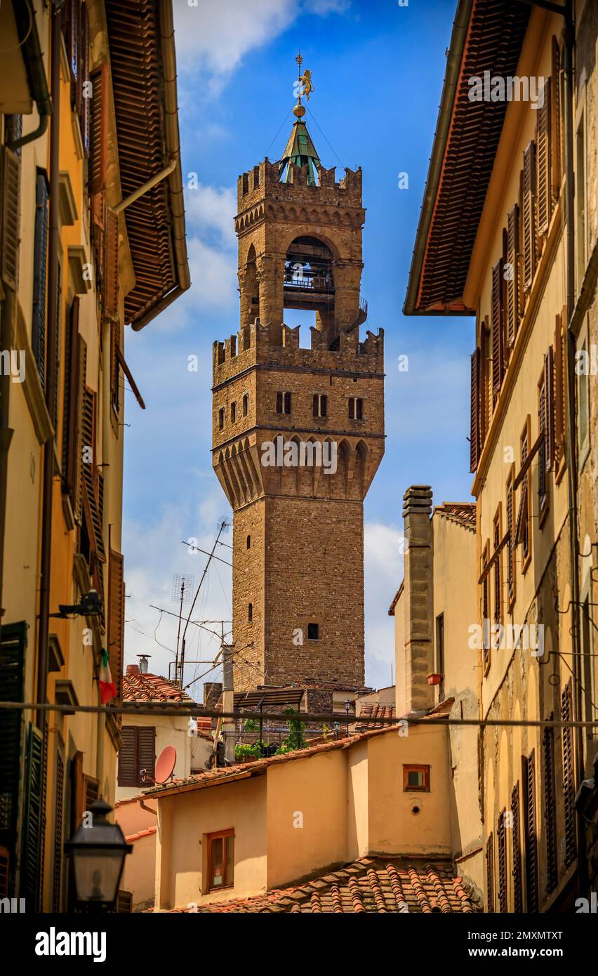 Tower of Palazzo Vecchio palace and medieval Renaissance gothic buildings along a narrow street, Centro Storico or Historic Centre of Florence, Italy Stock Photo