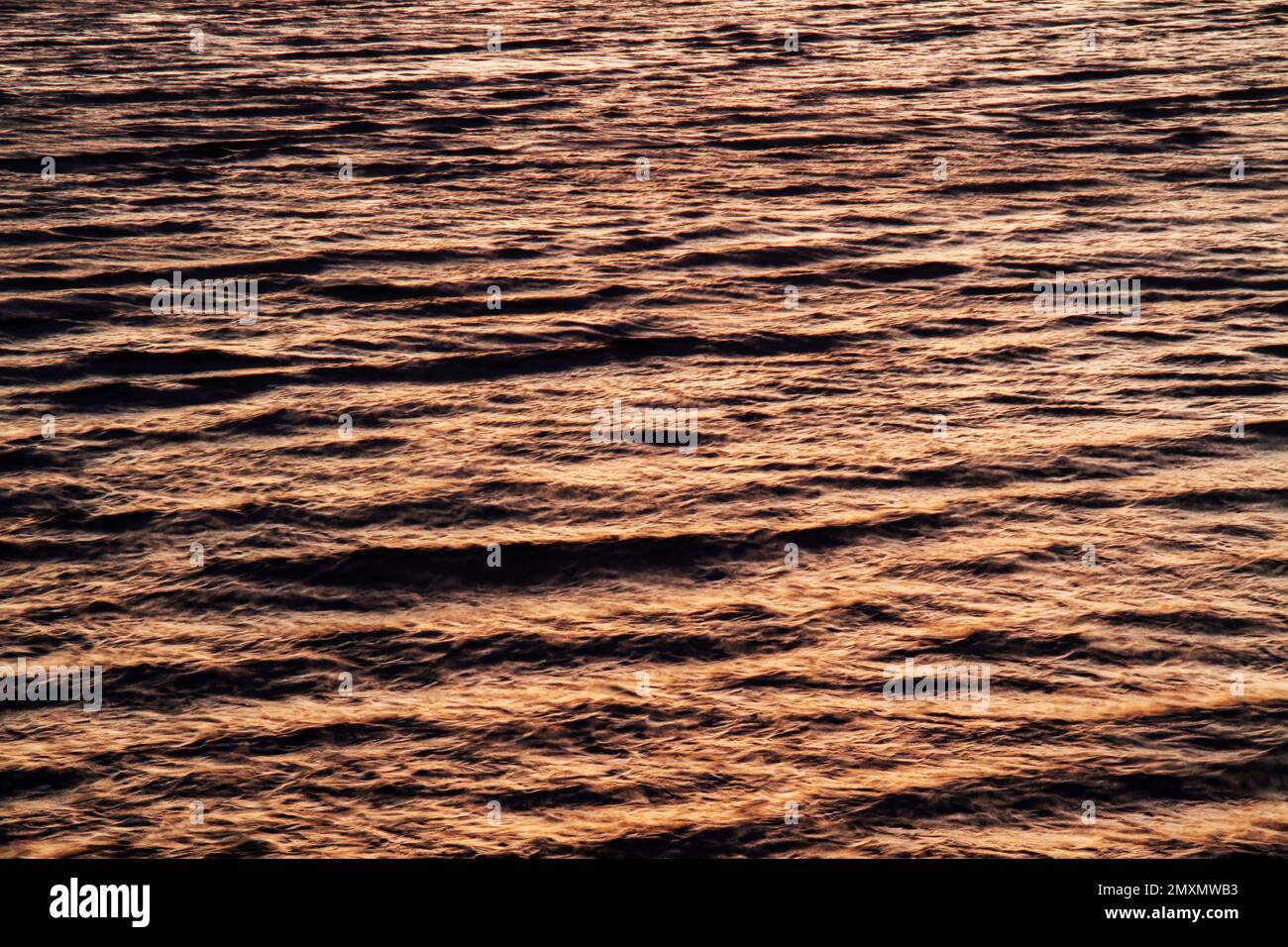 Reflecting sunset light off the surface of the water (2014) Stock Photo