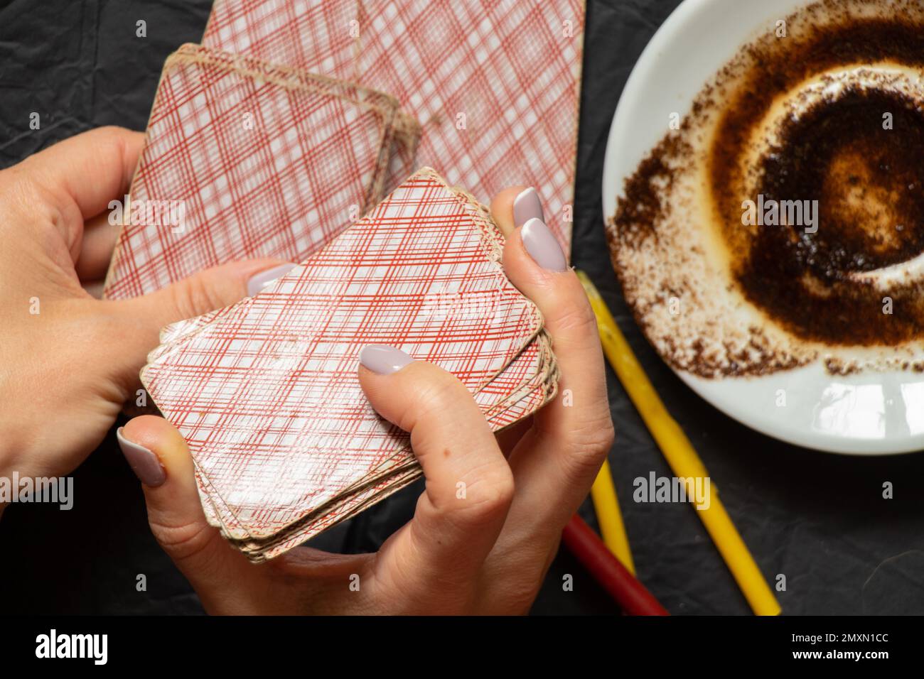 coffee grounds in the hands of a fortune teller and cards and candles