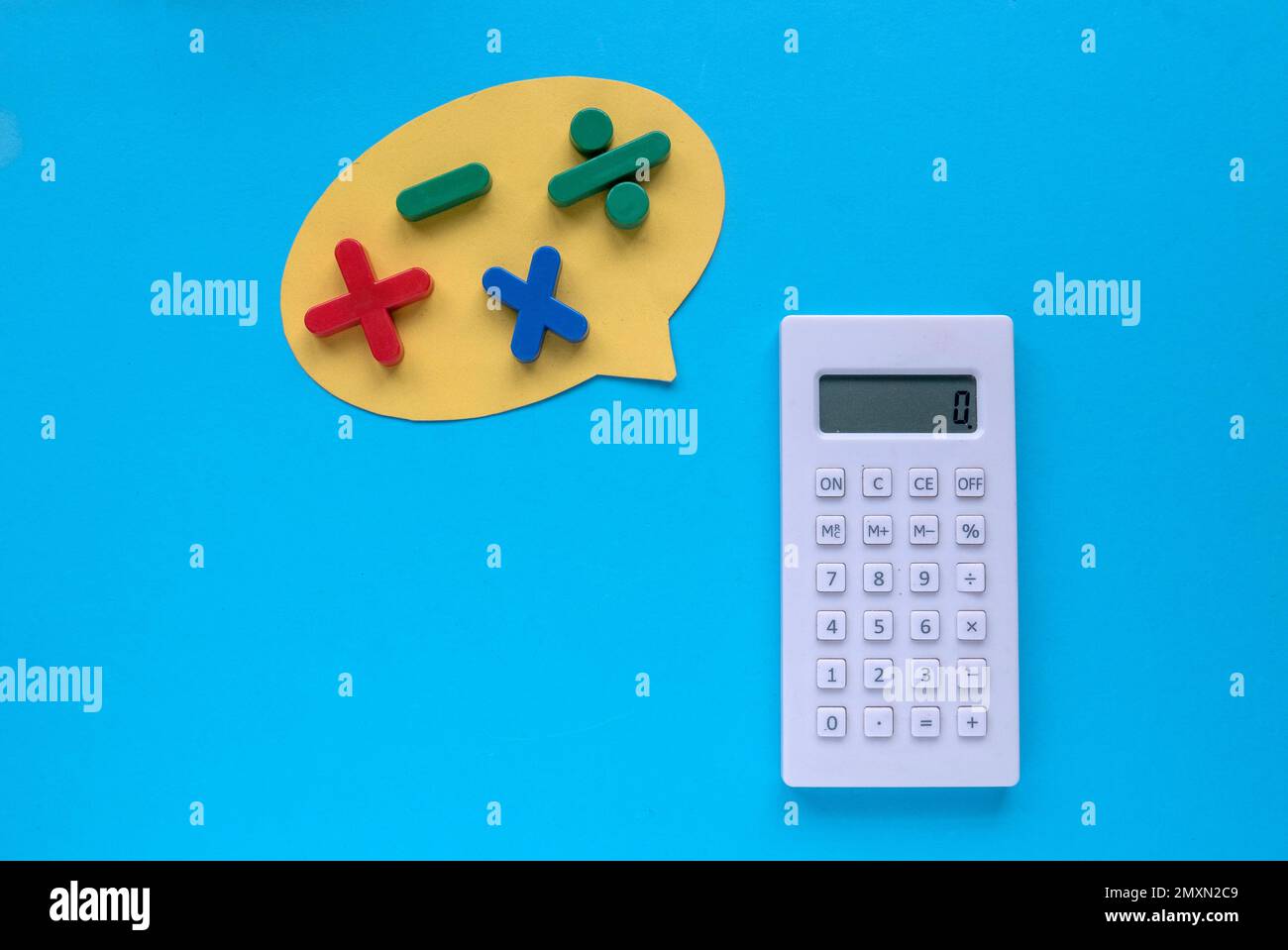 Colorful mathematical shape (Plus, minus, multiply, divide) and calculator on a blue background. Stock Photo