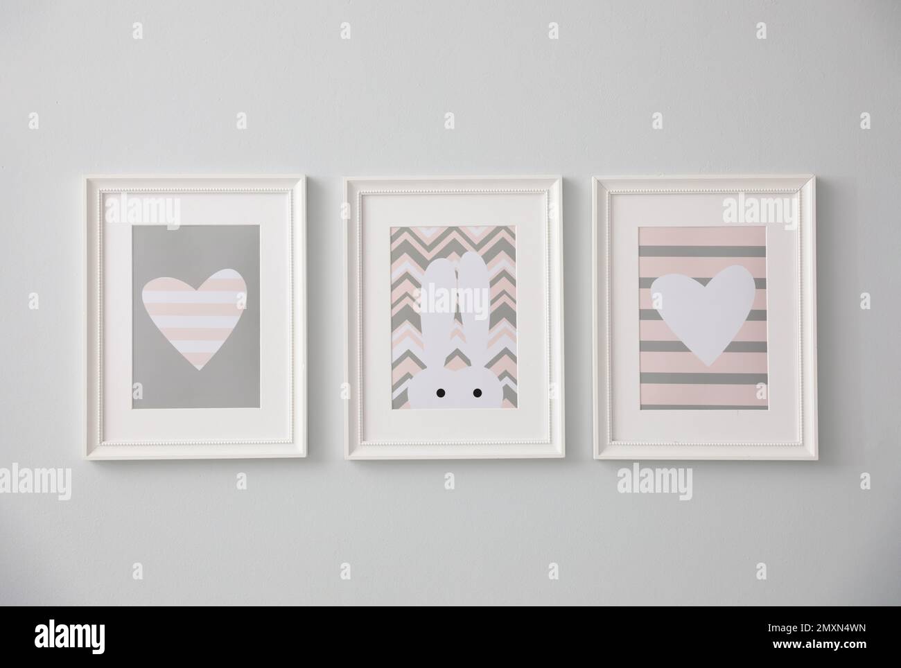 Different cute pictures on grey wall. Baby room interior Stock Photo