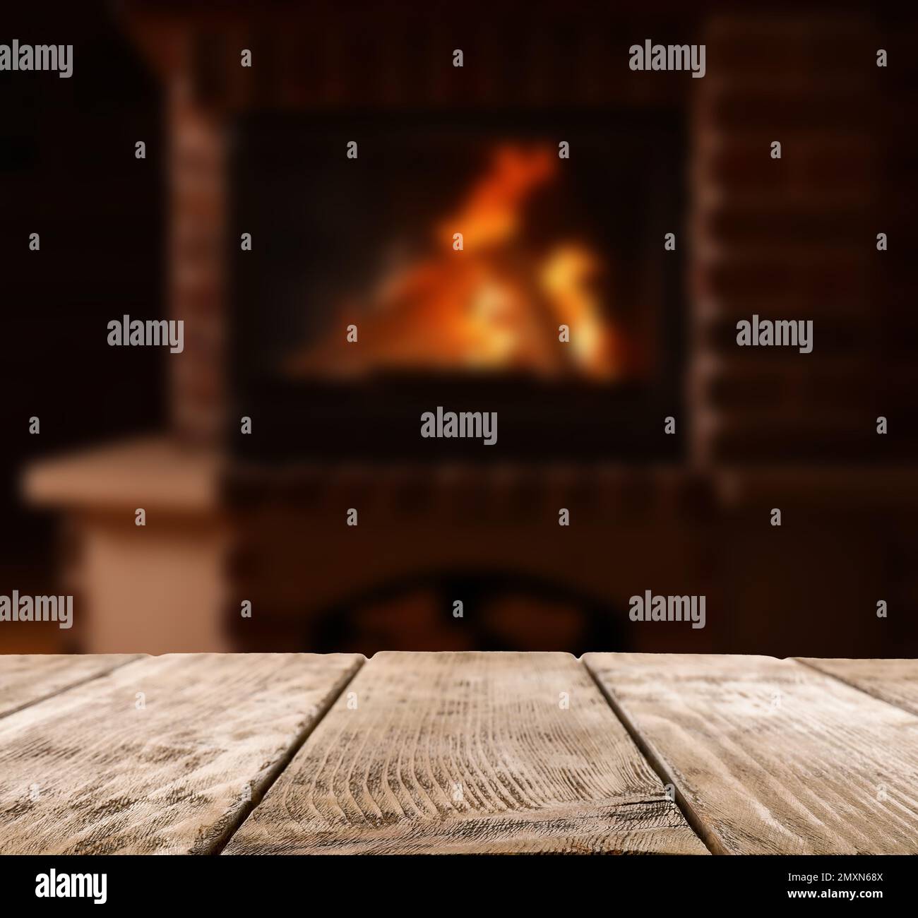 Rustic table and fireplace with burning wood indoors Stock Photo Alamy