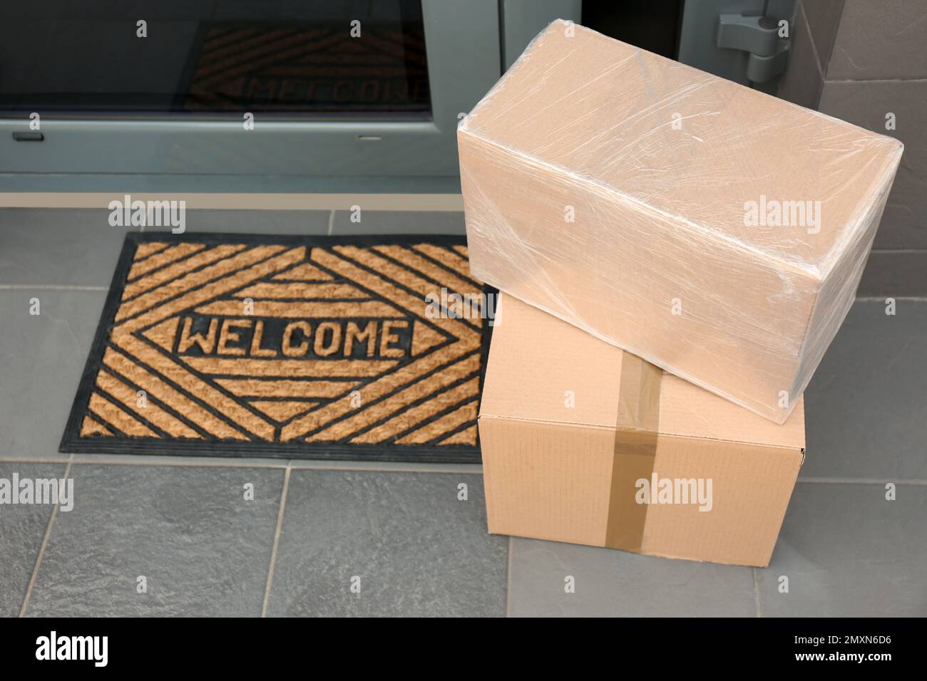 Cardboard boxes near door. Parcel delivery service Stock Photo Alamy