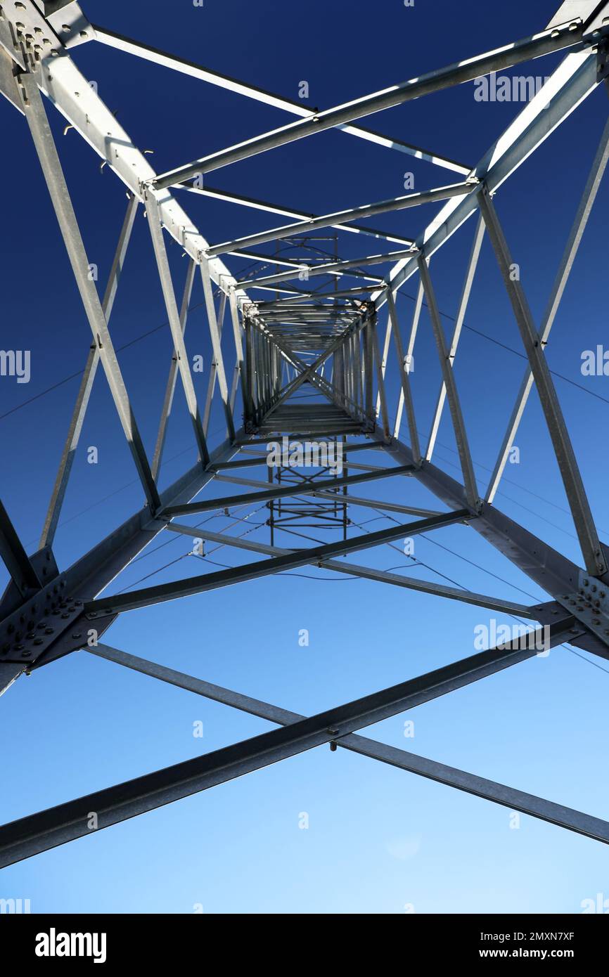 Modern high voltage tower against blue sky, bottom view Stock Photo - Alamy