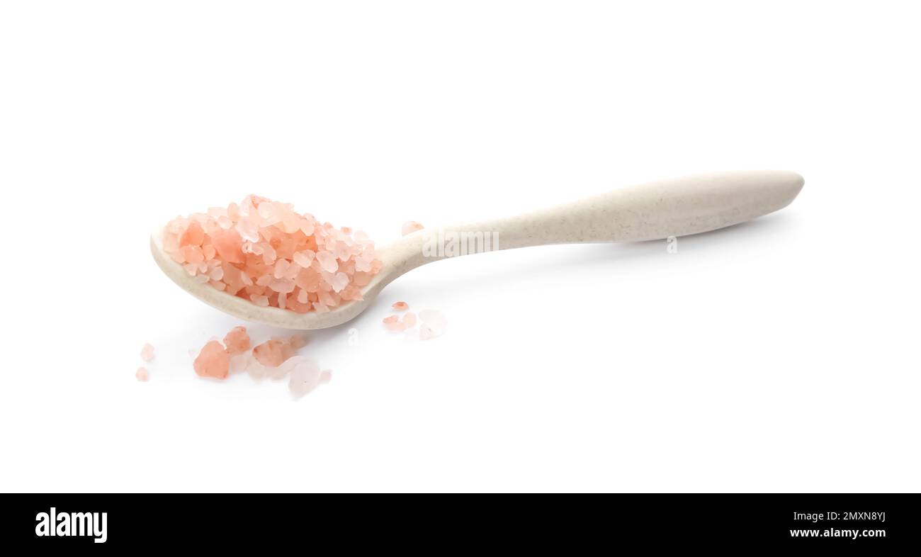 Spoon with pink himalayan salt isolated on white Stock Photo