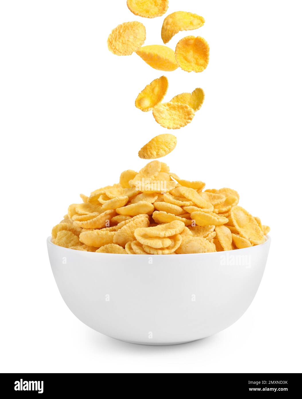 Tasty crispy corn flakes falling into bowl on white background. Breakfast cereal Stock Photo
