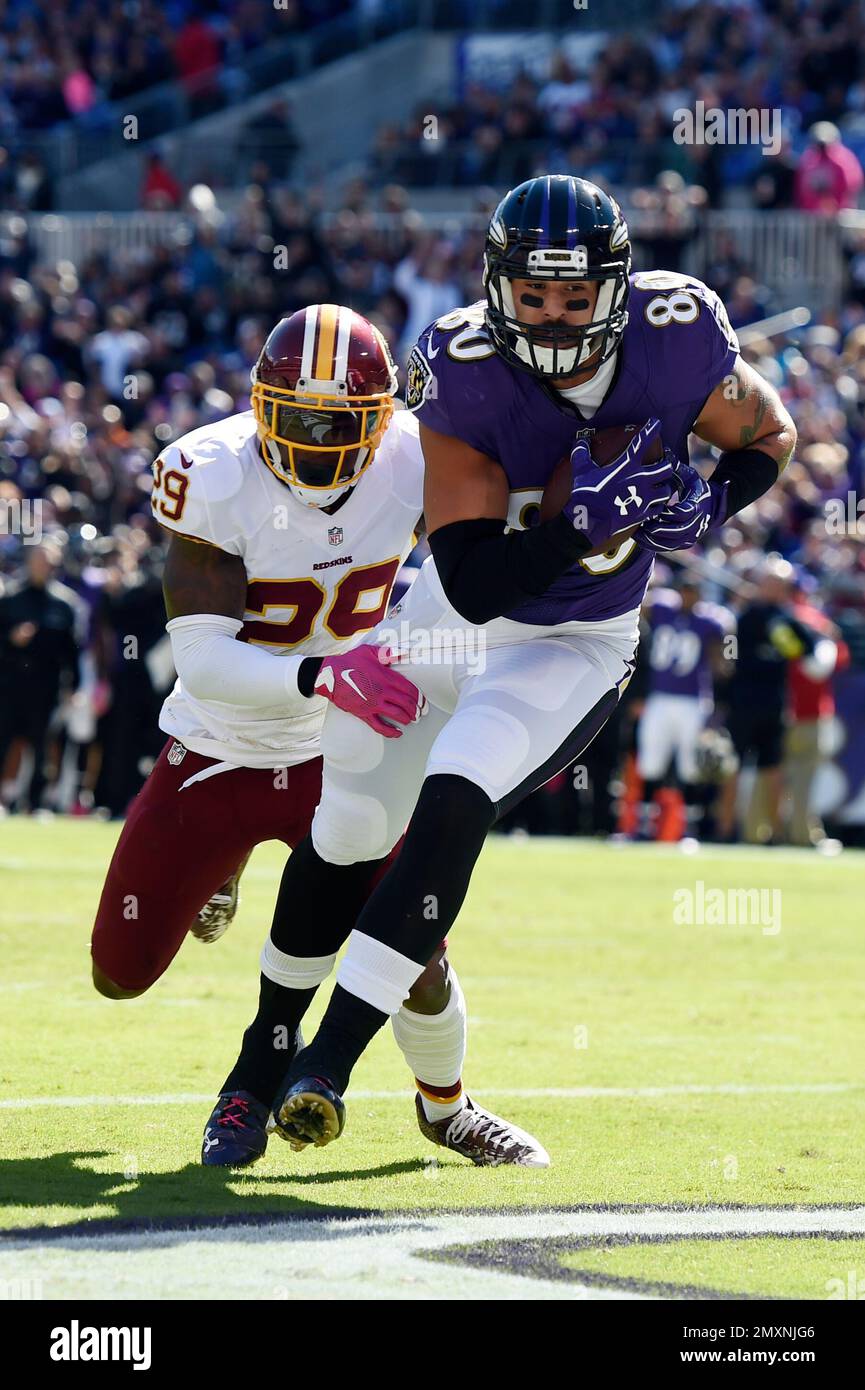 Baltimore Ravens' Crockett Gillmore (80) pulls in a touchdown pass