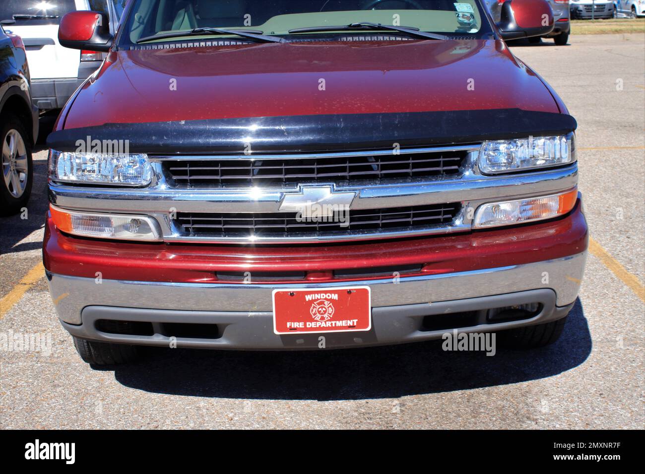 A Chevrolet Pickup grill shot closeup in a parking lot with the Emblem with a chrome grill Stock