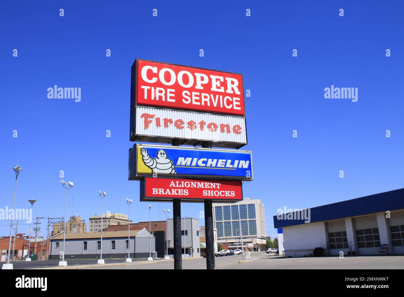COOPER Tire Service sign with blue sky Stock Photo