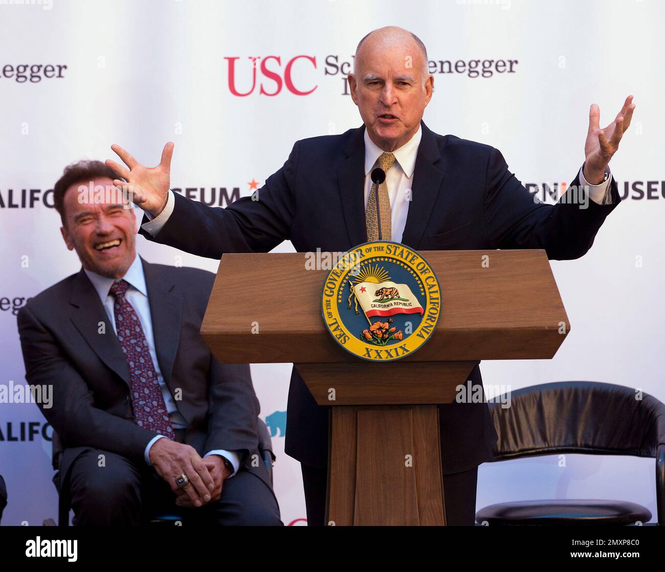 Former Gov. Arnold Schwarzenegger, left, laughs a remarks made by Gov. Jerry Brown during a celebration of the 10th Anniversary of Schwarzenegger signing California's landmark global warming bill, AB32, Wednesday, Oct. 5, 2016, in Sacramento, Calif. (AP Photo/Rich Pedroncelli) Stock Photo