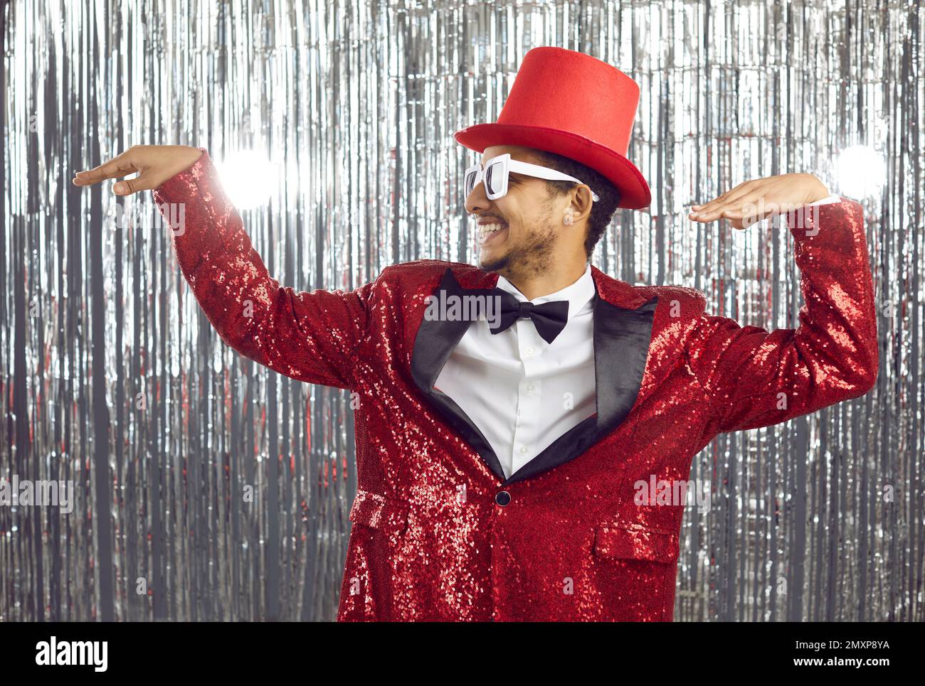 Smiling black male entertainer in festive costume dancing Stock Photo