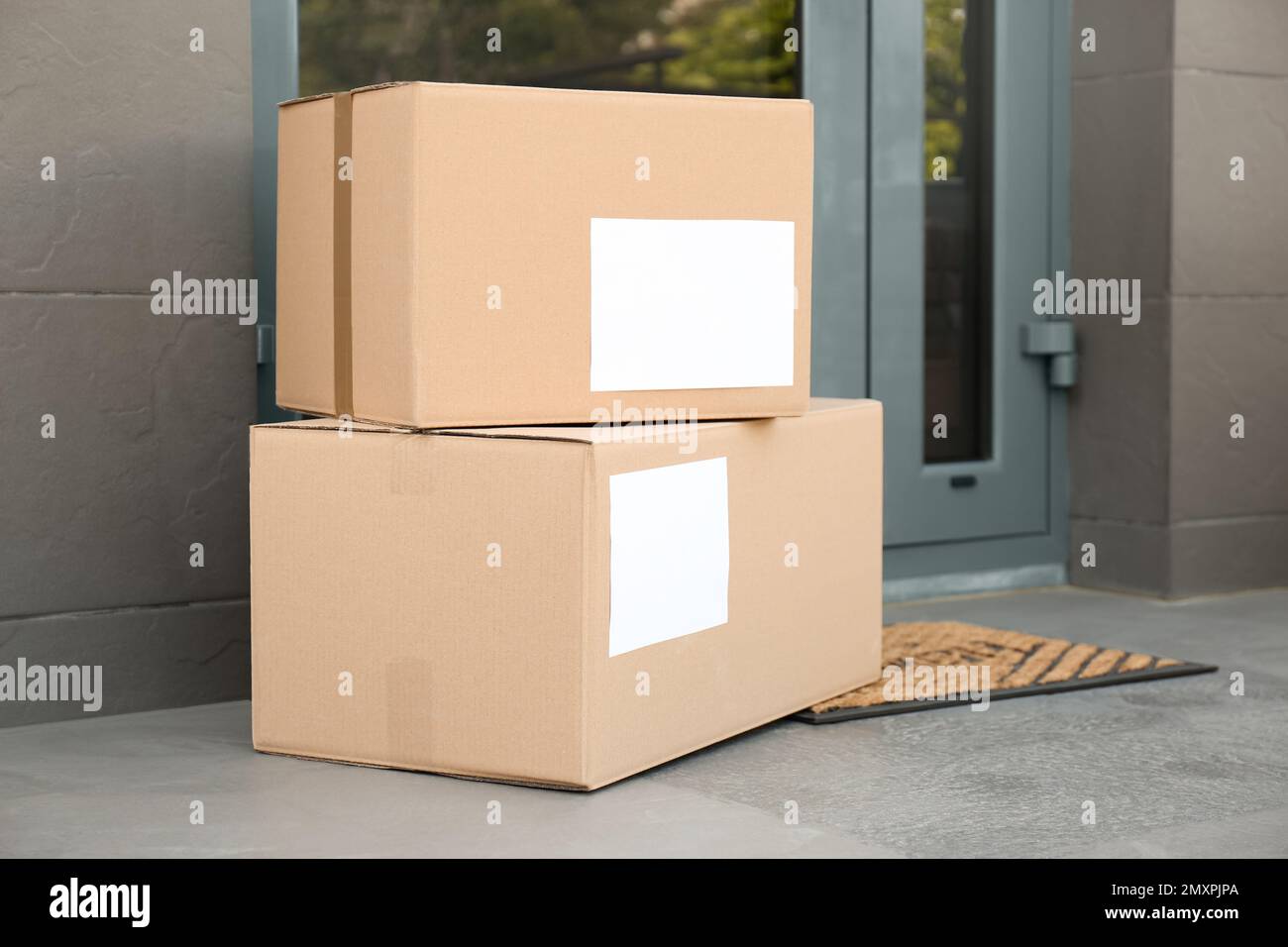 Cardboard boxes near door. Parcel delivery service Stock Photo Alamy