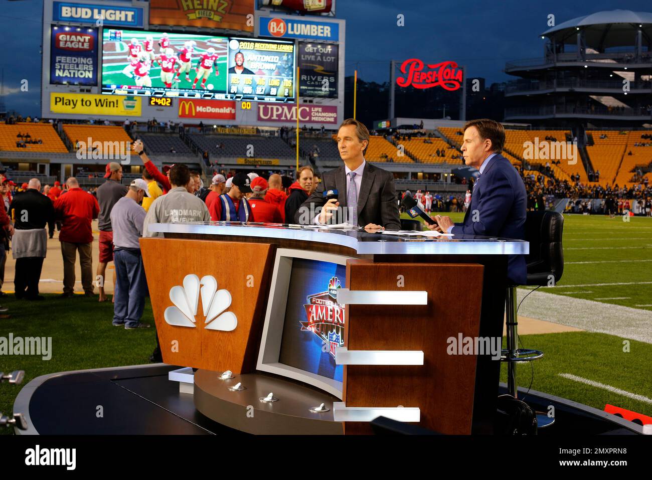 NBC Sunday Night Football announcers Chris Colliningsworth, center, and