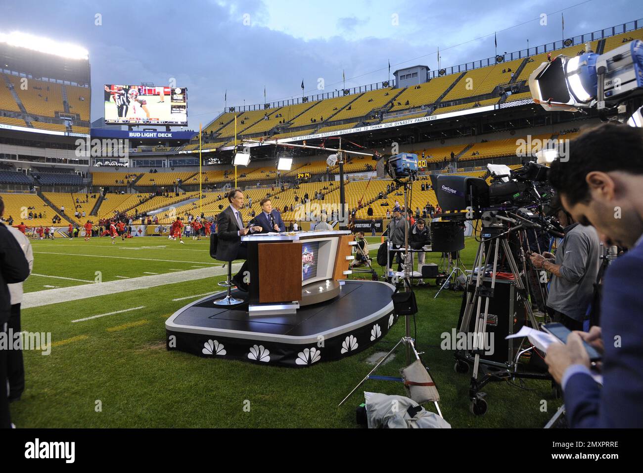 NBC Sunday Night Football announcers Chris Colliningsworth, center, and