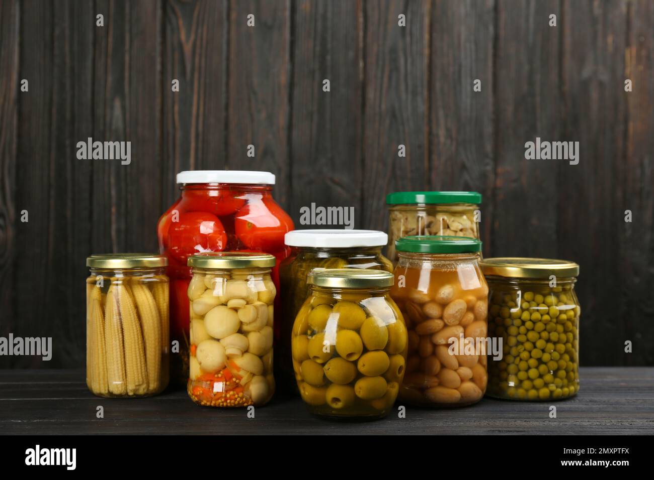 https://c8.alamy.com/comp/2MXPTFX/glass-jars-with-different-pickled-vegetables-and-mushrooms-on-wooden-background-2MXPTFX.jpg