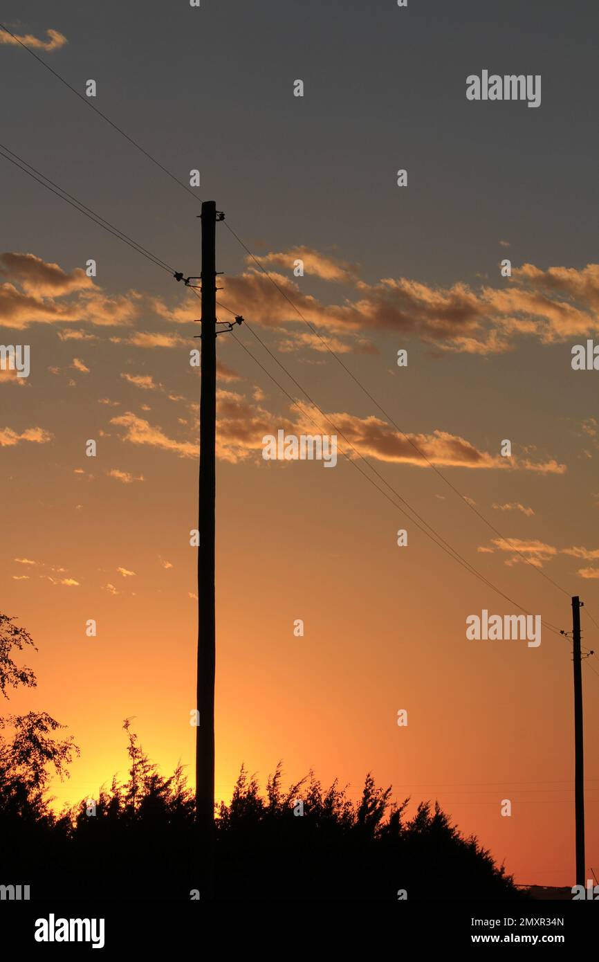 Kansas Power lines silhouette at Sunset with clouds Stock Photo