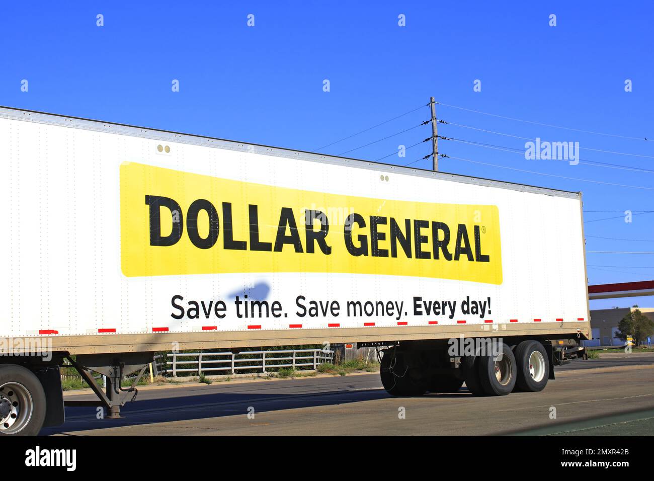 Dollar General delivery Semi truck at a Dollar General with blue sky in