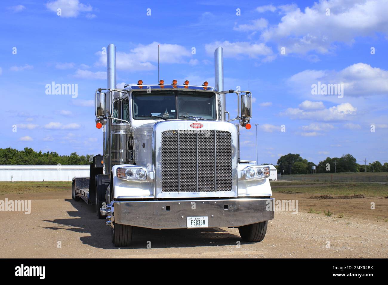 Peterbilt White Diesel in a parking lot with blue sky and clouds Stock ...