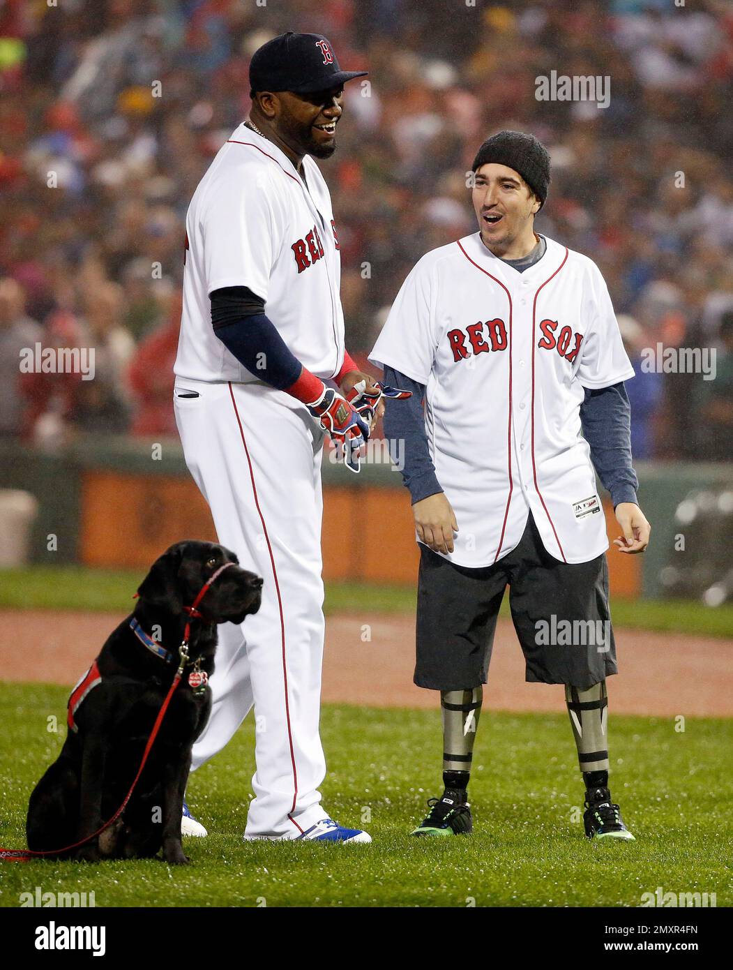 Boston Marathon bombing victim Jeff Bauman, right, stands with Boston Red  Sox's David Ortiz after throwing out a ceremonial first pitch following  ceremonies to honor Ortiz before a baseball game against the