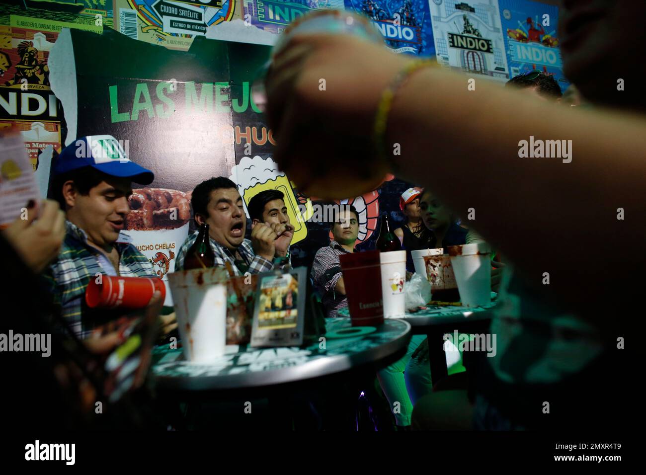 Visitors drink together at the first Michelada Expo in Mexico City