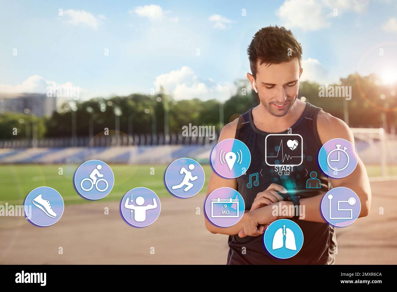 Man using smart watch during training outdoors. Icons near hand with device Stock Photo