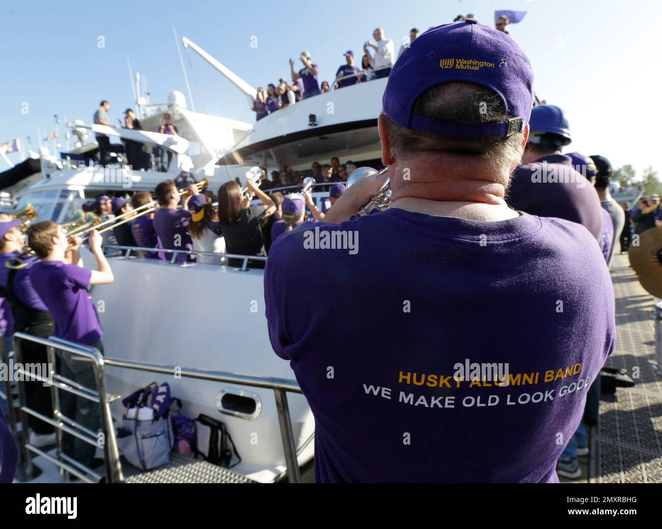 Washington fans "sailgate" on the "Big Dawg" yacht as the Husky Alumni Band plays while docked outside Husky Stadium before the start of an NCAA college football game between Washington and Stanford, Friday, Sept. 30, 2016, in Seattle. In addition to the usual parking lot pre-game festivities, the stadium's location on Lake Washington draws crowds on boats as well. (AP Photo/Ted S. Warren) Stock Photo