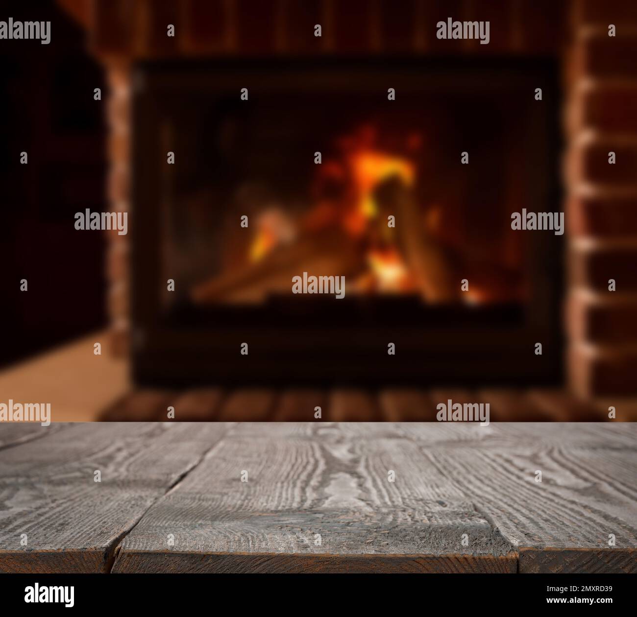 Rustic table and fireplace with burning wood indoors Stock Photo Alamy