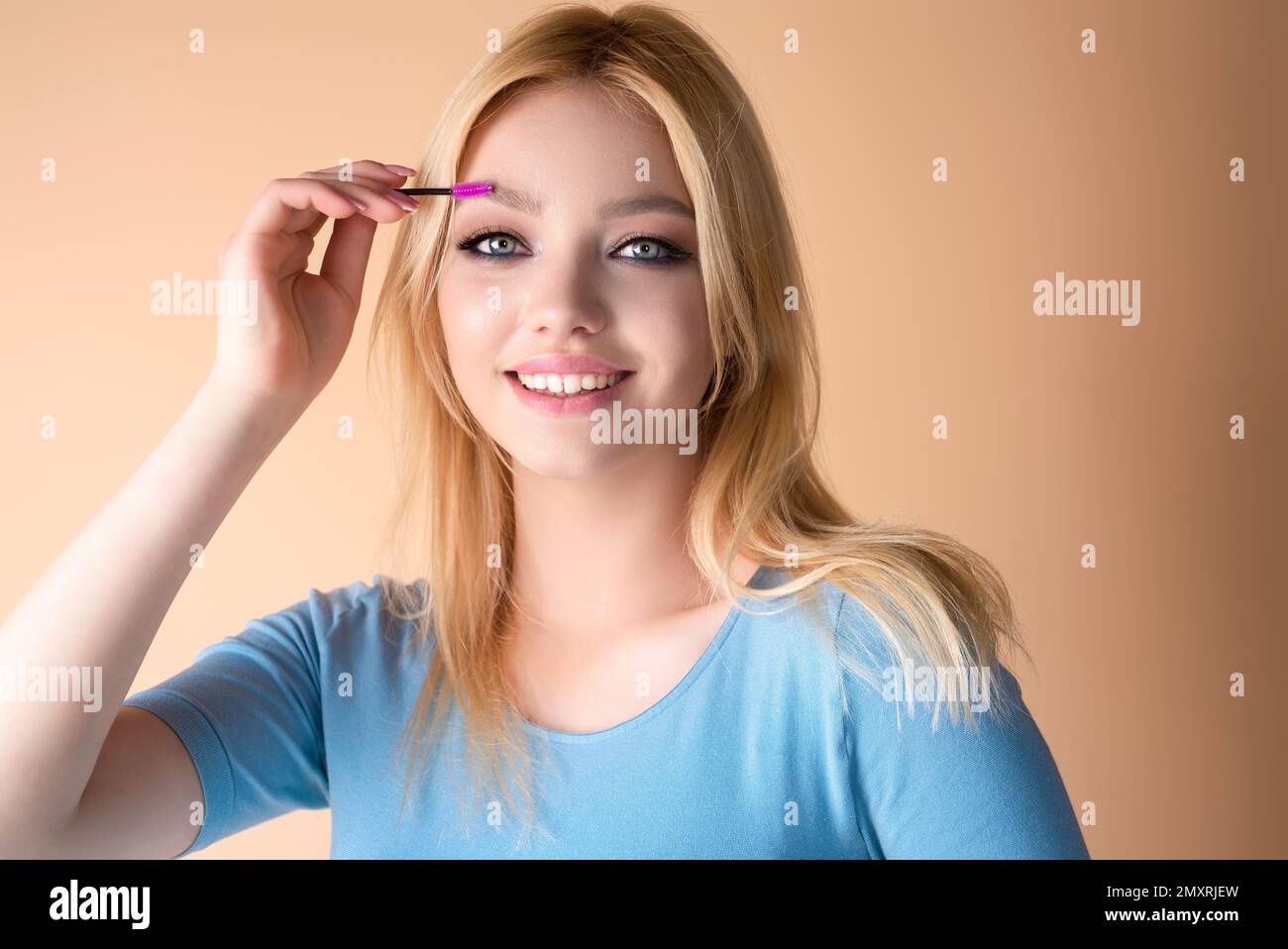 Eyebrow shaping, woman combs eyebrows with a brus. Eyebrow line. Makeup