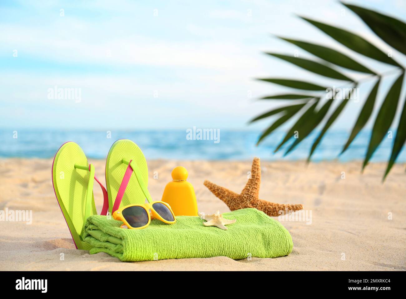 Different stylish beach objects and starfish on sand near sea Stock ...