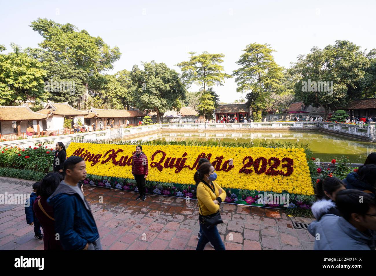 Hanoi, Vietnam, January 2023.  visitors in the large park with the historic buildings inside the temple of literature Stock Photo