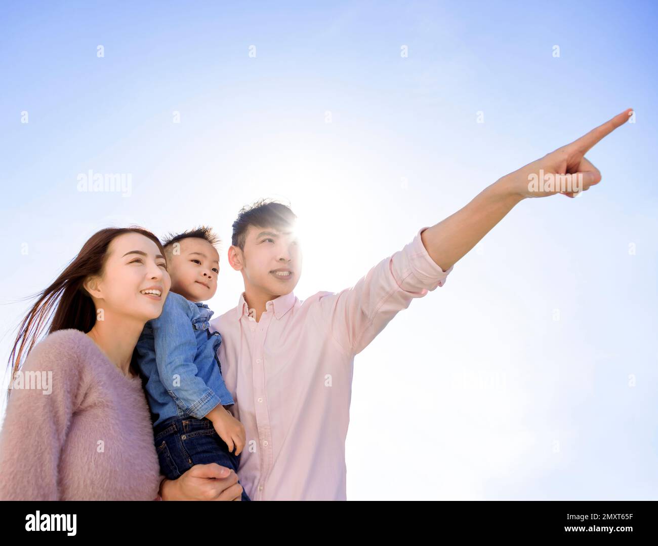 Happy family  standing and looking up Stock Photo