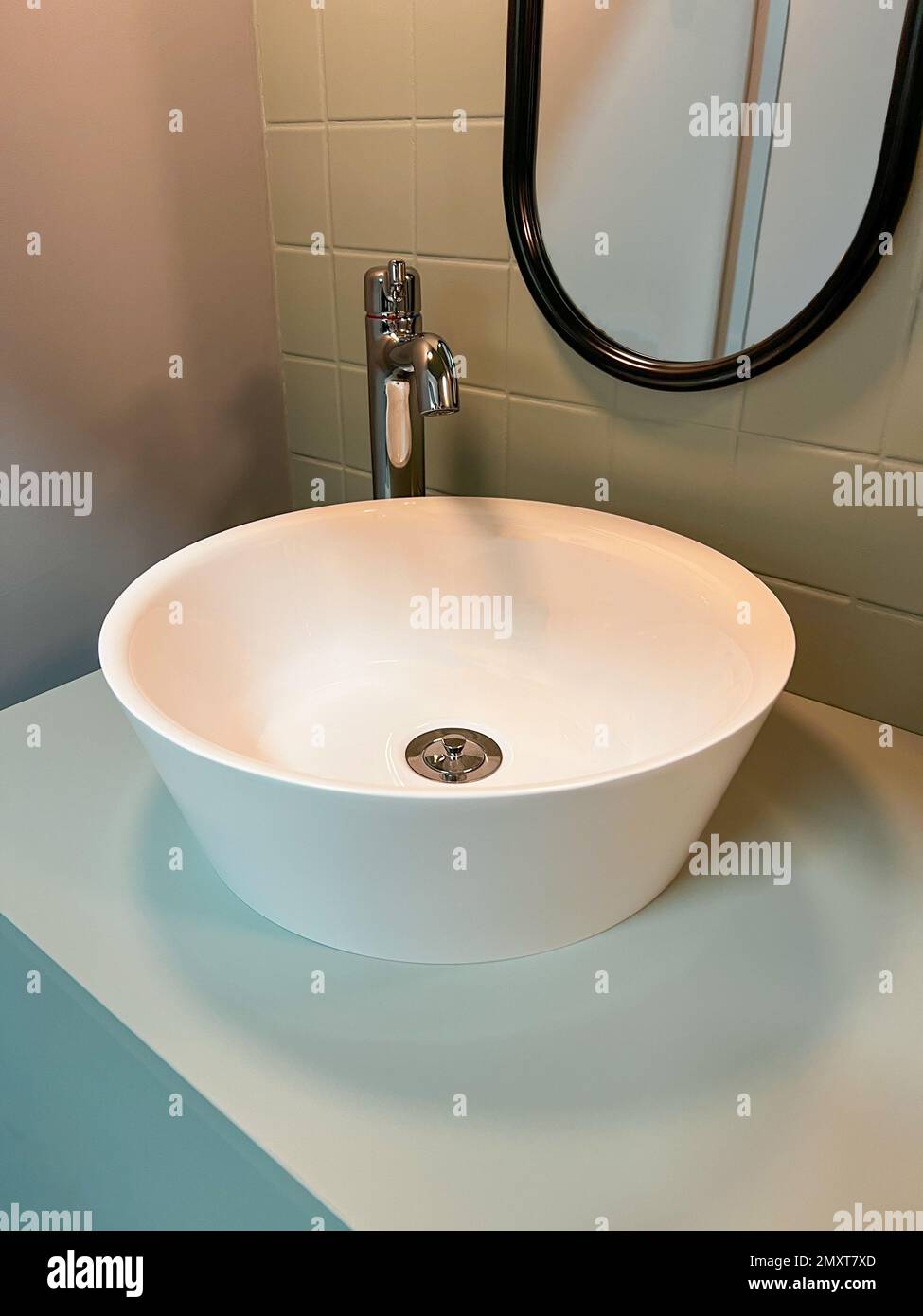 luxury bathroom decor, white sink on light blue cabinet Stock Photo - Alamy