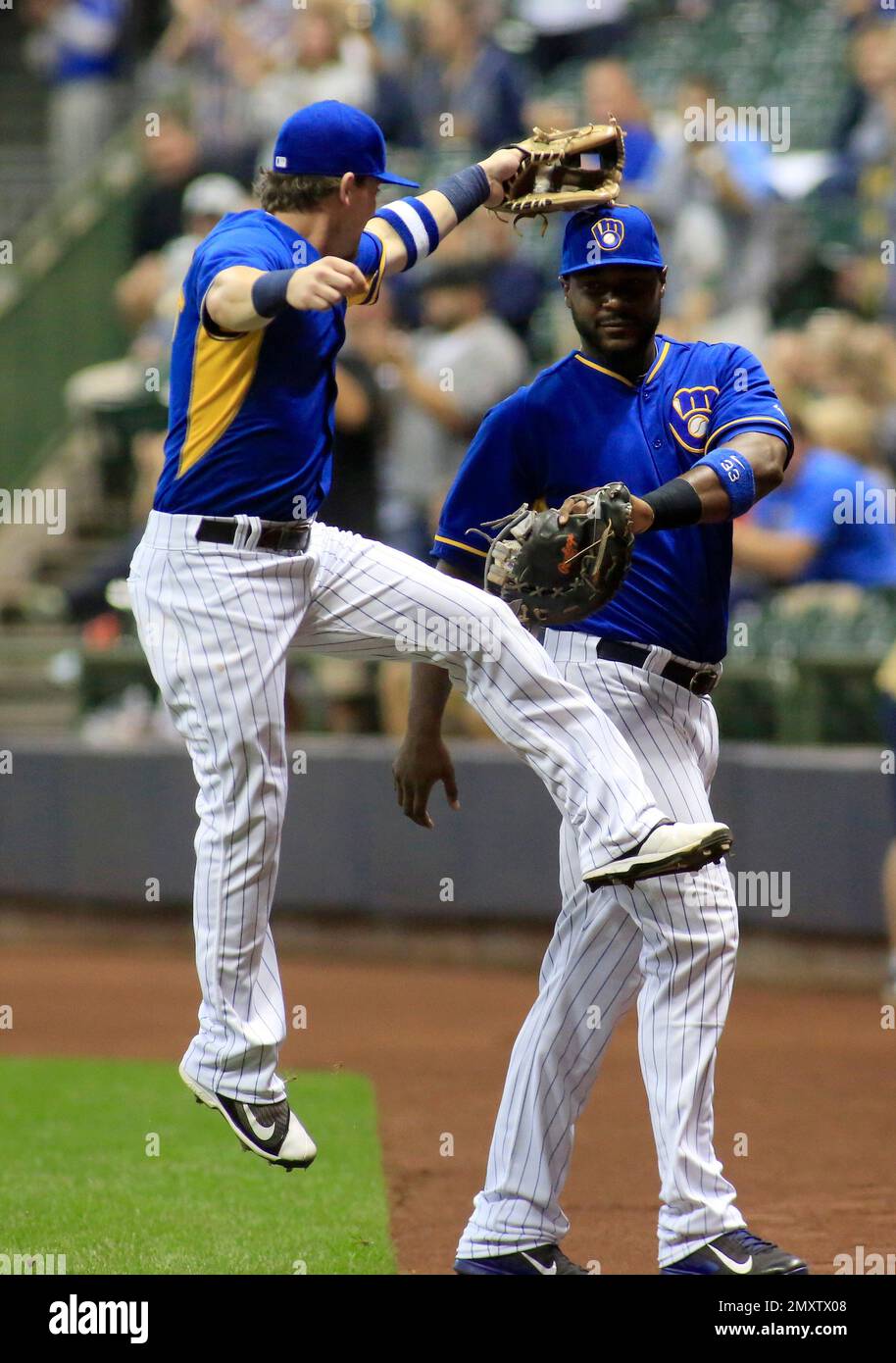 Milwaukee Brewers second baseman Scooter Gennett, left, reacts with first  baseman Chris Carter, right, after Carter turned a triple play against the  Cincinnati Reds during the first inning of a baseball game