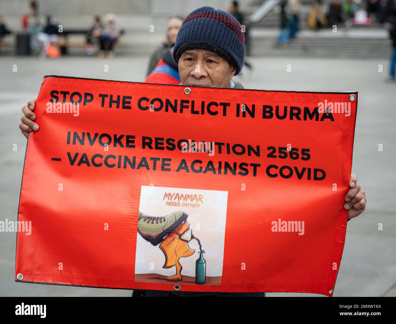 Burmese protester holds banner in London's Trafalgar Square to mark the two-year anniversary of a military coup in Myanmar. Protest, London January 23 Stock Photo