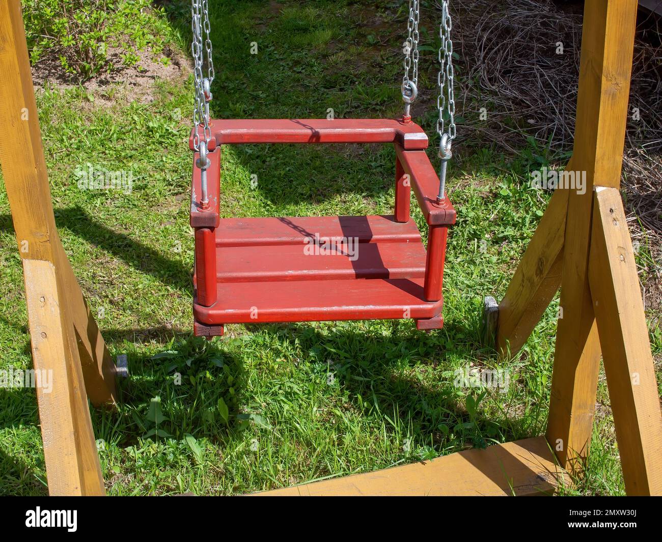 wooden swing in the village, in spring Stock Photo