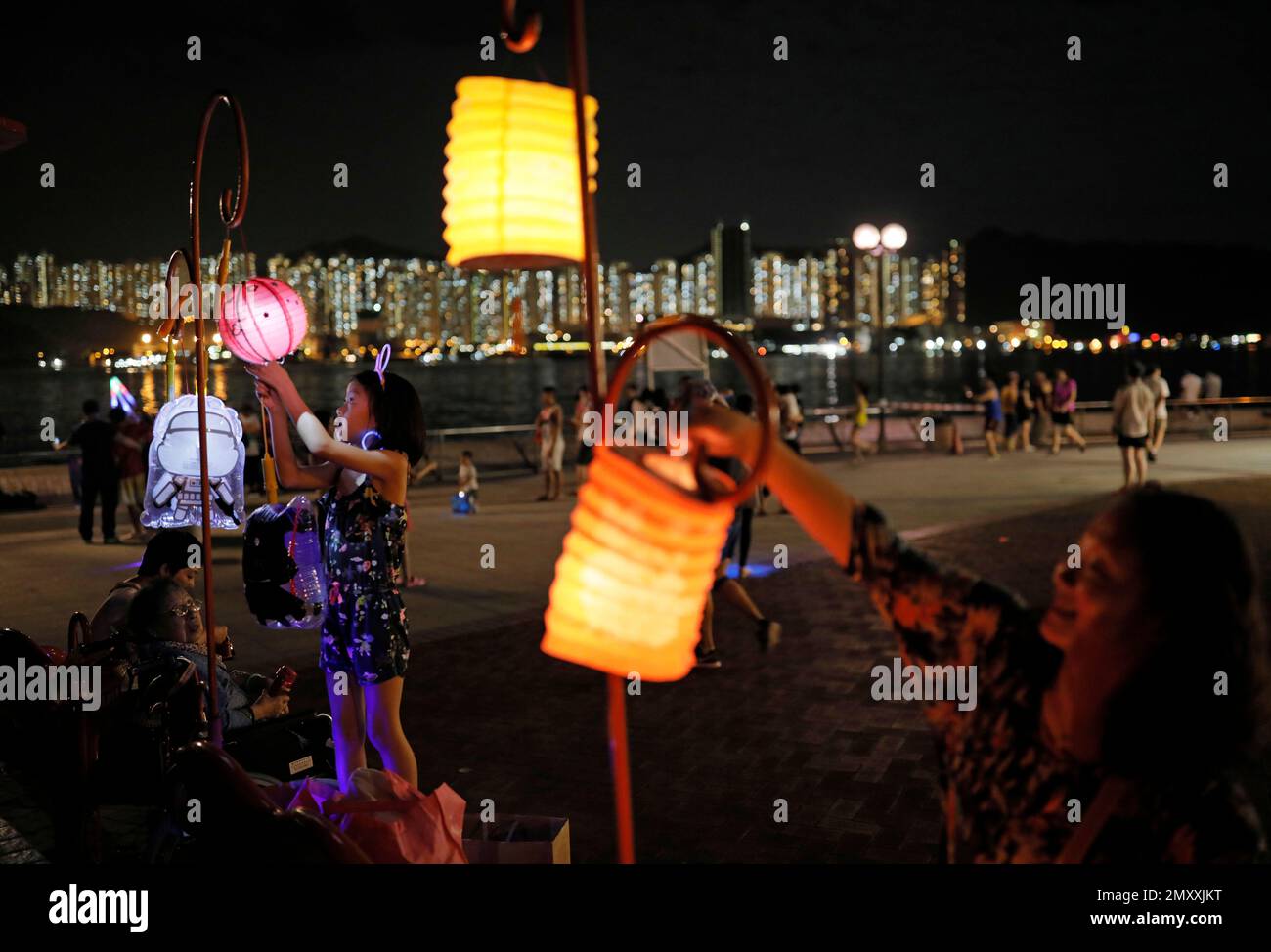 Residents light up lanterns during the Chinese Mid-Autumn Festival at a ...