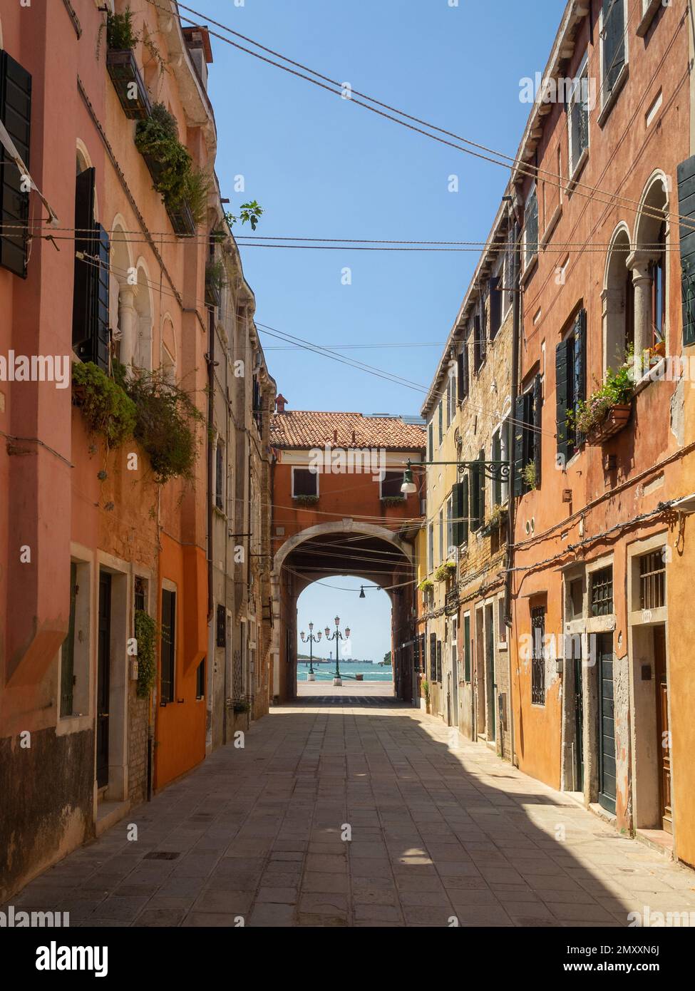 An empty Castello street with the lagoon at the end, Venice Stock Photo