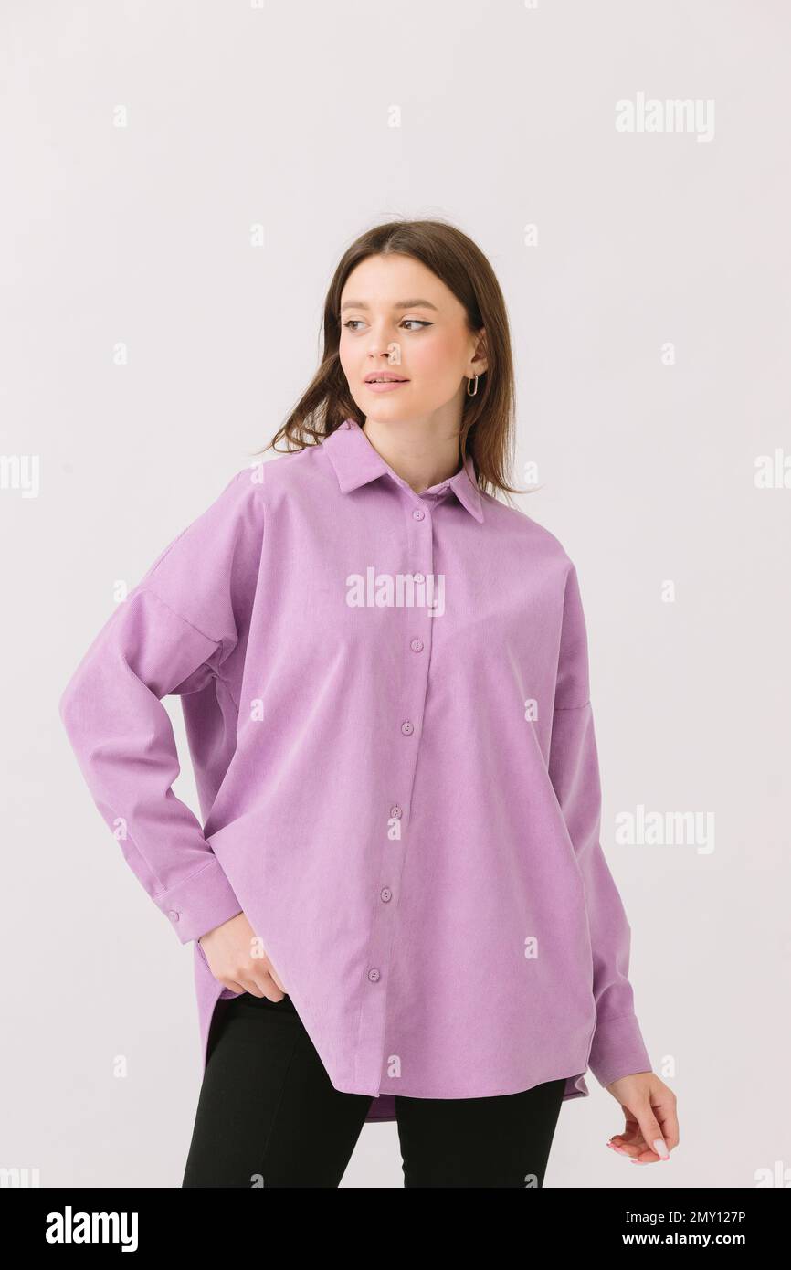 Photo of a beautiful brunette woman in a colored purple shirt isolated ...
