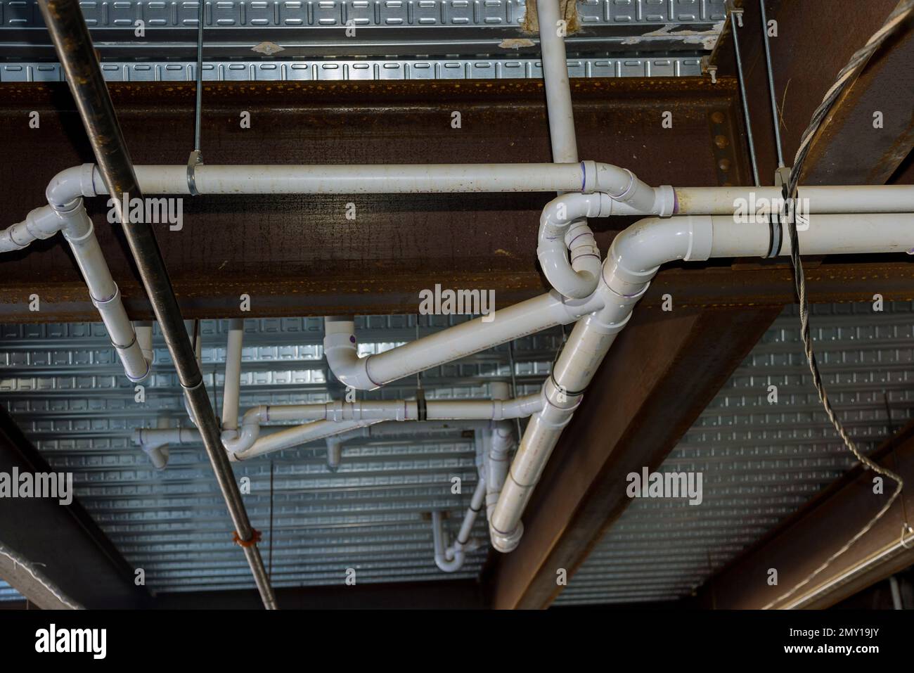 System for assembling waste pipes under ceiling of an apartment