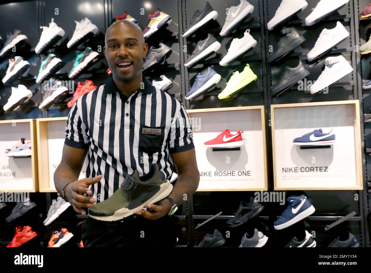 In this Thursday, Aug. 25, 2016, photo, store manager Terry Williams talks  about Nike's Sock Dart Running Shoe at Foot Locker's redesigned flagship  store in midtown Manhattan, in New York. (AP Photo/Mary